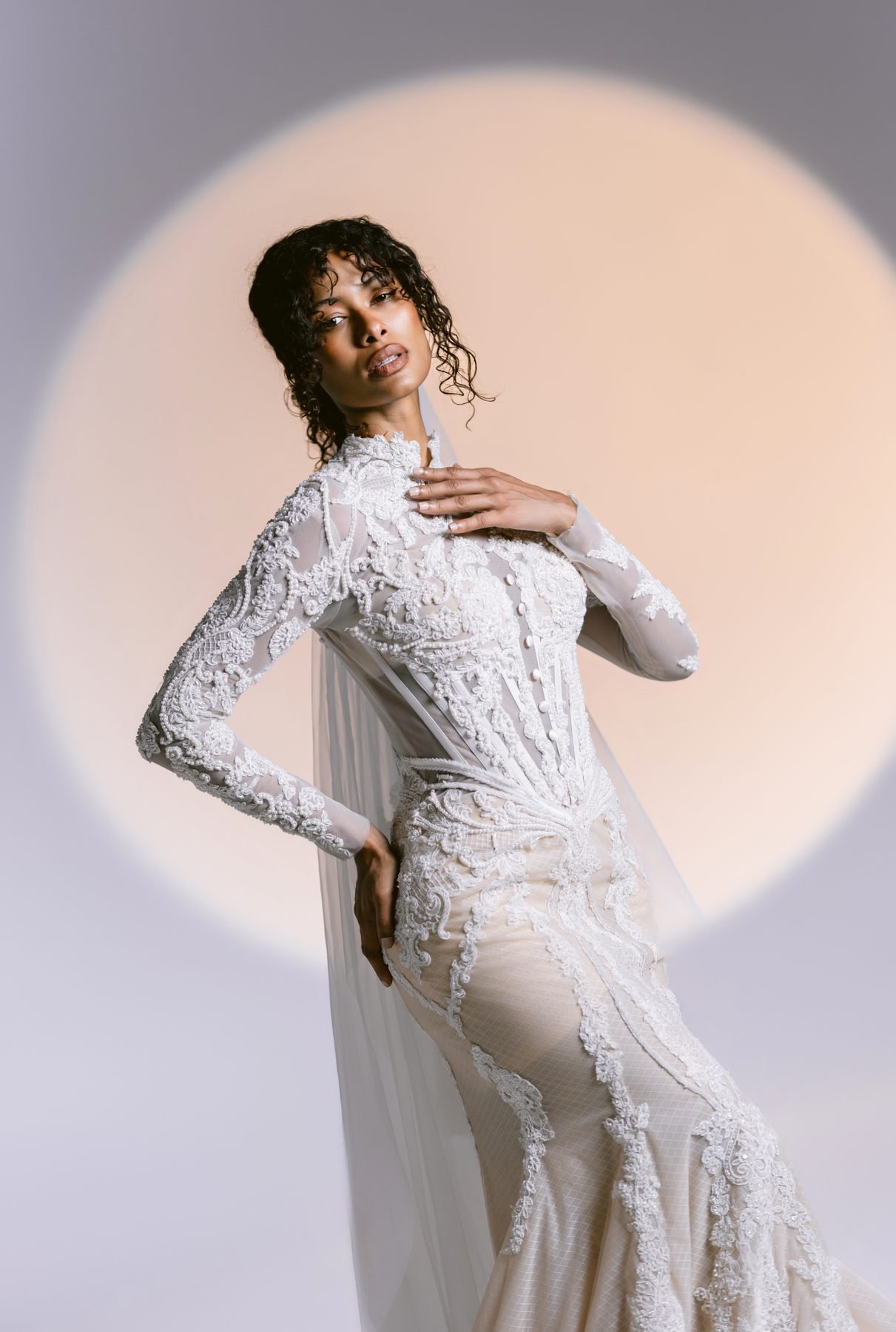 High-neck lace gown with cape