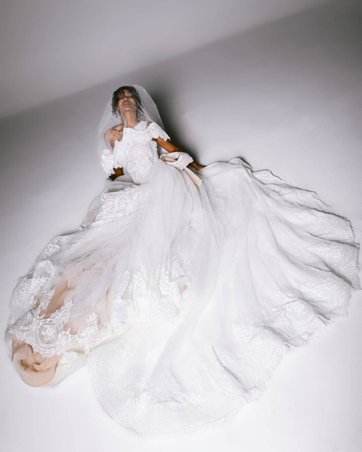 Bride lying in layers of tulle
