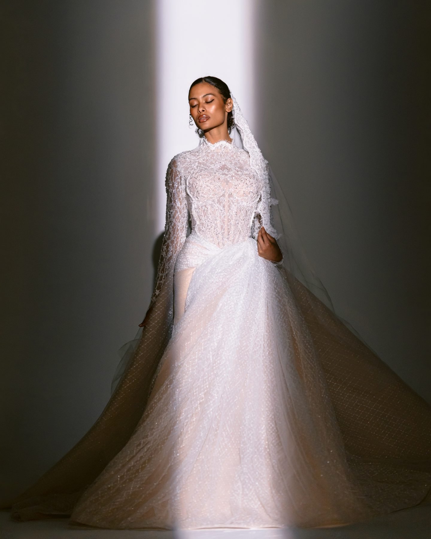 Bride standing in a beam of light