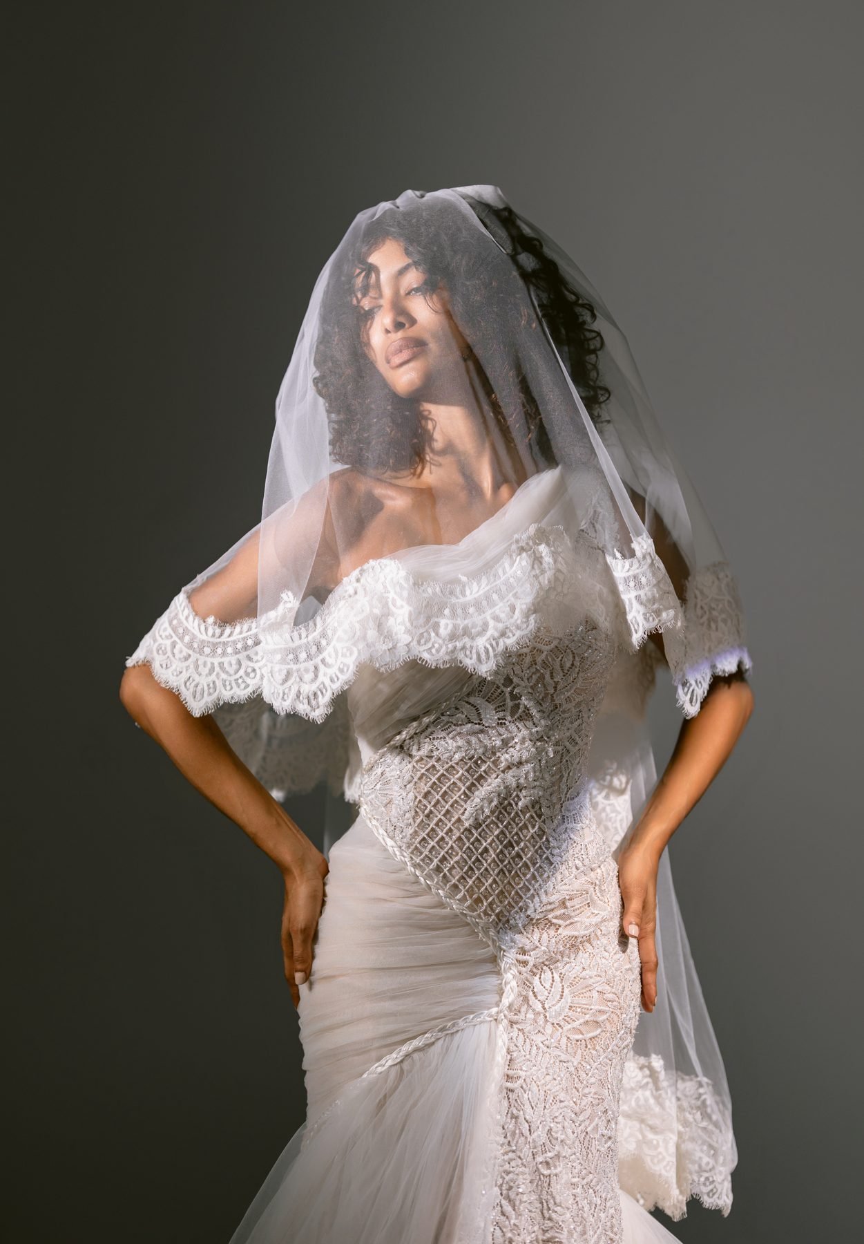 Bride with lace-trimmed veil over her face